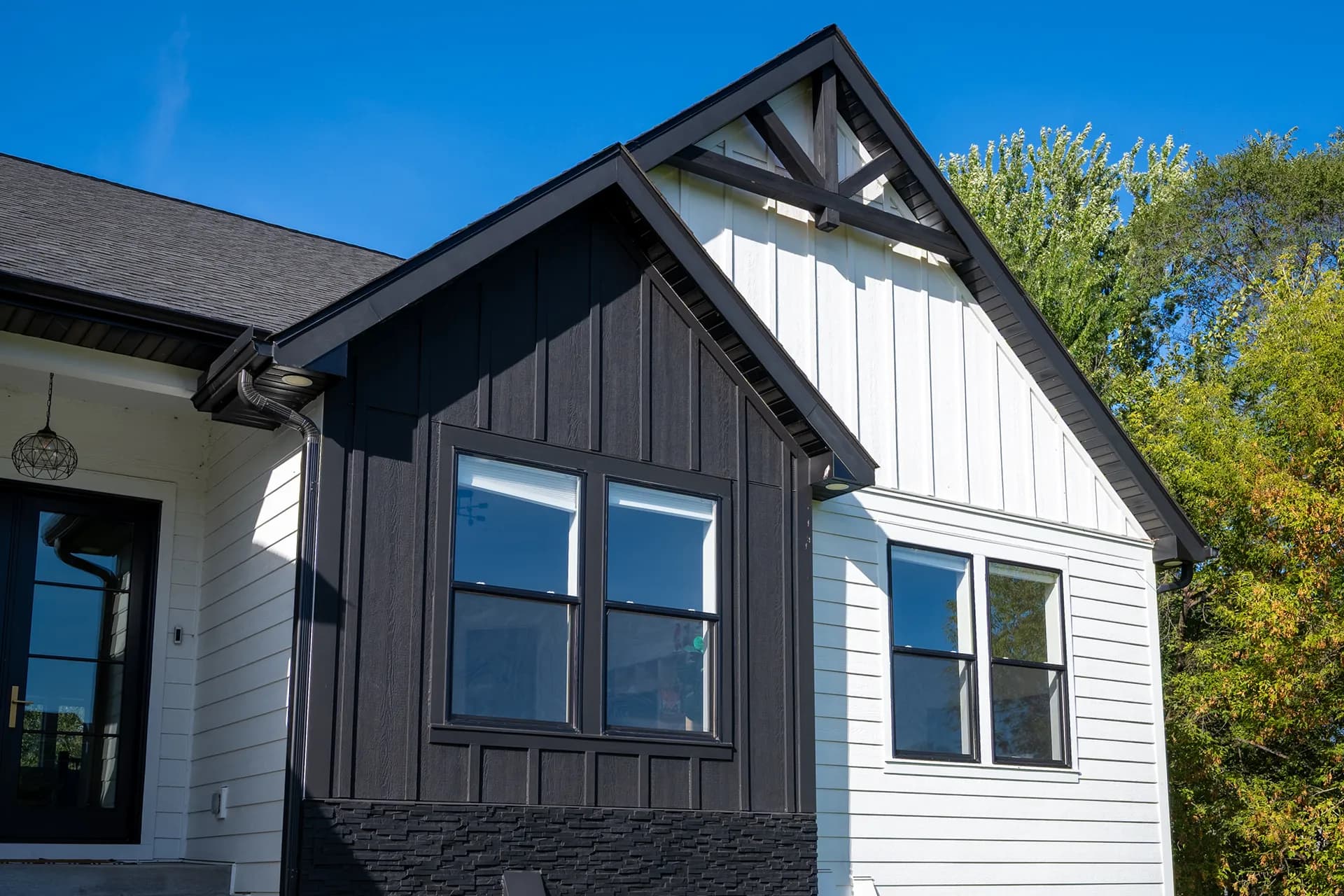 Siding and trim detail of Otsego Construction in Otsego, Minnesota, featuring James Hardie Lap Siding and James Hardie Vertical Panels and Board-and-Batten.