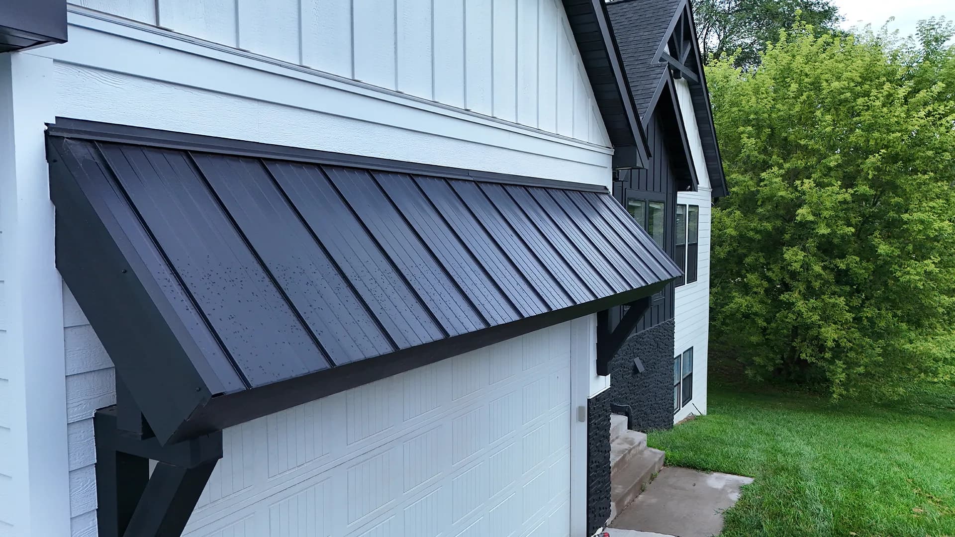 Standing-seam metal roof detail on an Otsego exterior project